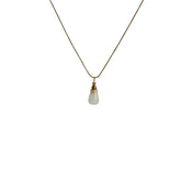 Natural agate ashes necklace hanging on gold chain, product close-up