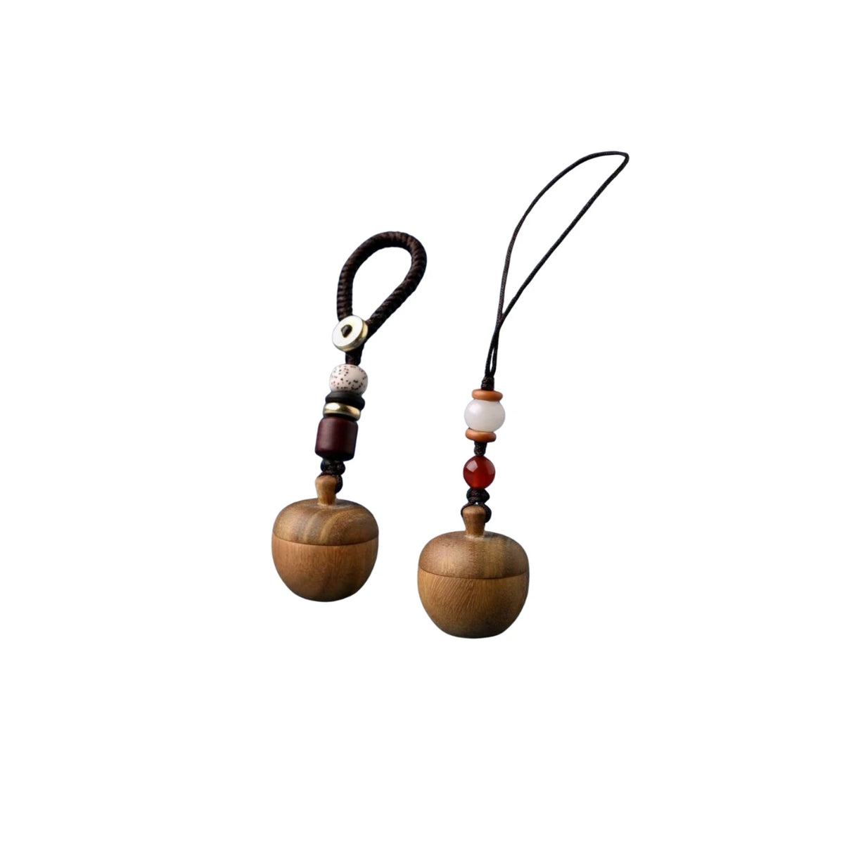 Two apple-shaped wooden keepsake urn keychains with bead charms and loop cords, natural finish, small ashes holder