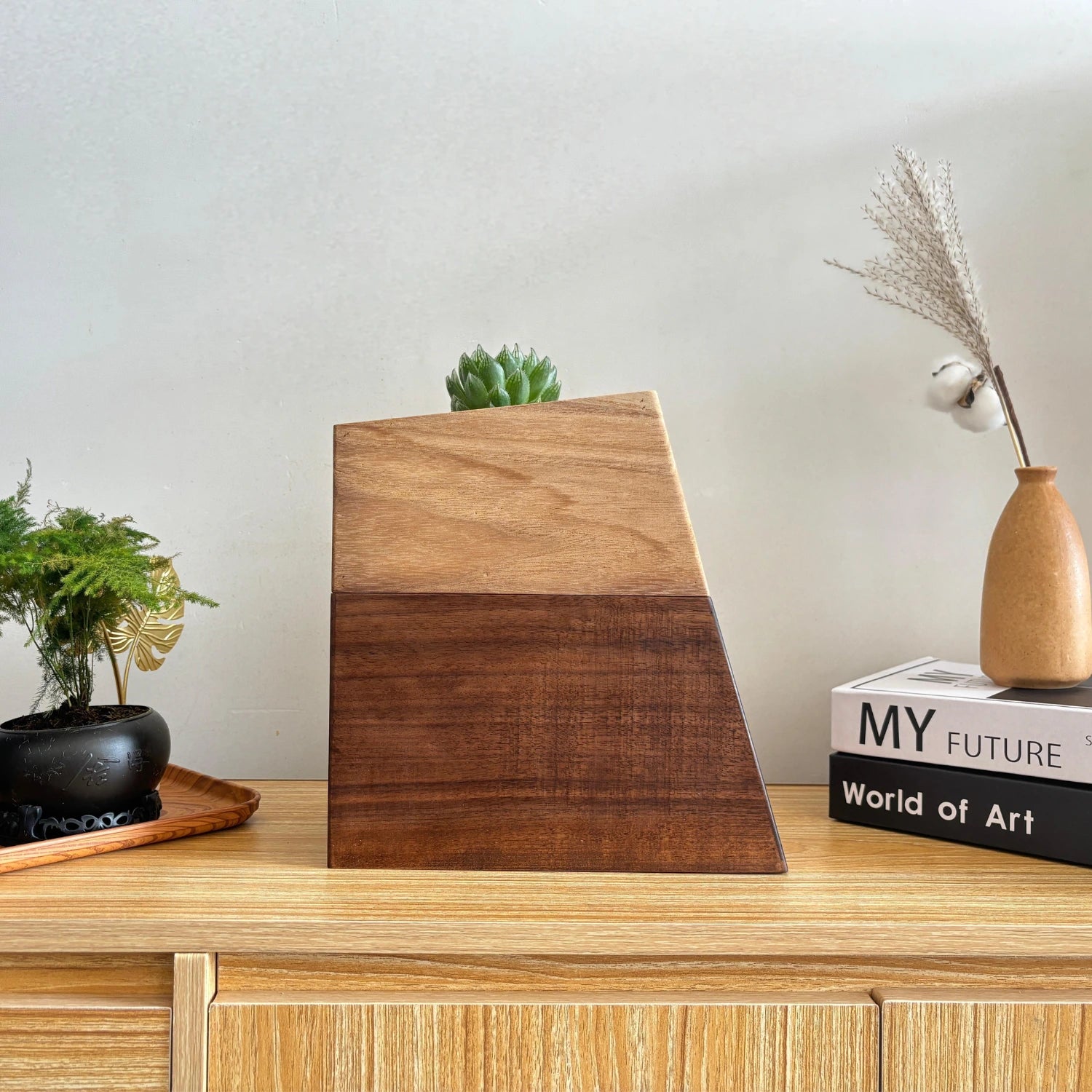 Black walnut vase pet urn placed on cabinet for real-life display