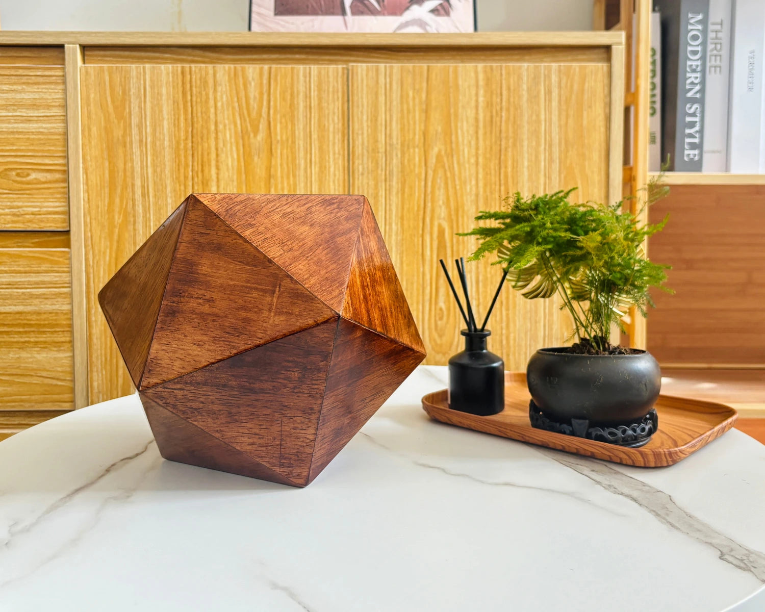 Black walnut icosahedron pet urn placed on table