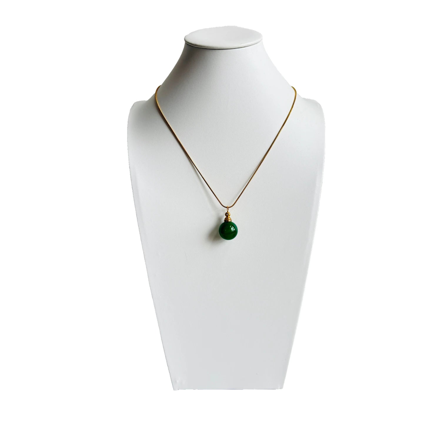 Green agate cremation pendant displayed on a white mannequin bust with gold chain, elegant memorial jewellery design.