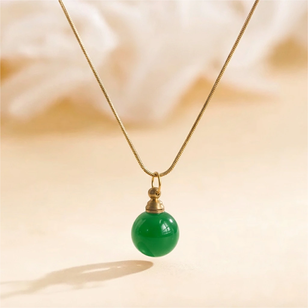 Green agate urn necklace photographed on warm beige background with natural sunlight, symbol of peace and renewal.