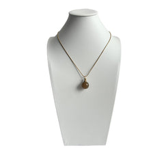 Round yellow agate urn pendant displayed on a mannequin with gold snake chain, soft neutral lighting.