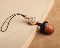 Pine Cone Urn Keychain — wooden keepsake capsule on desk