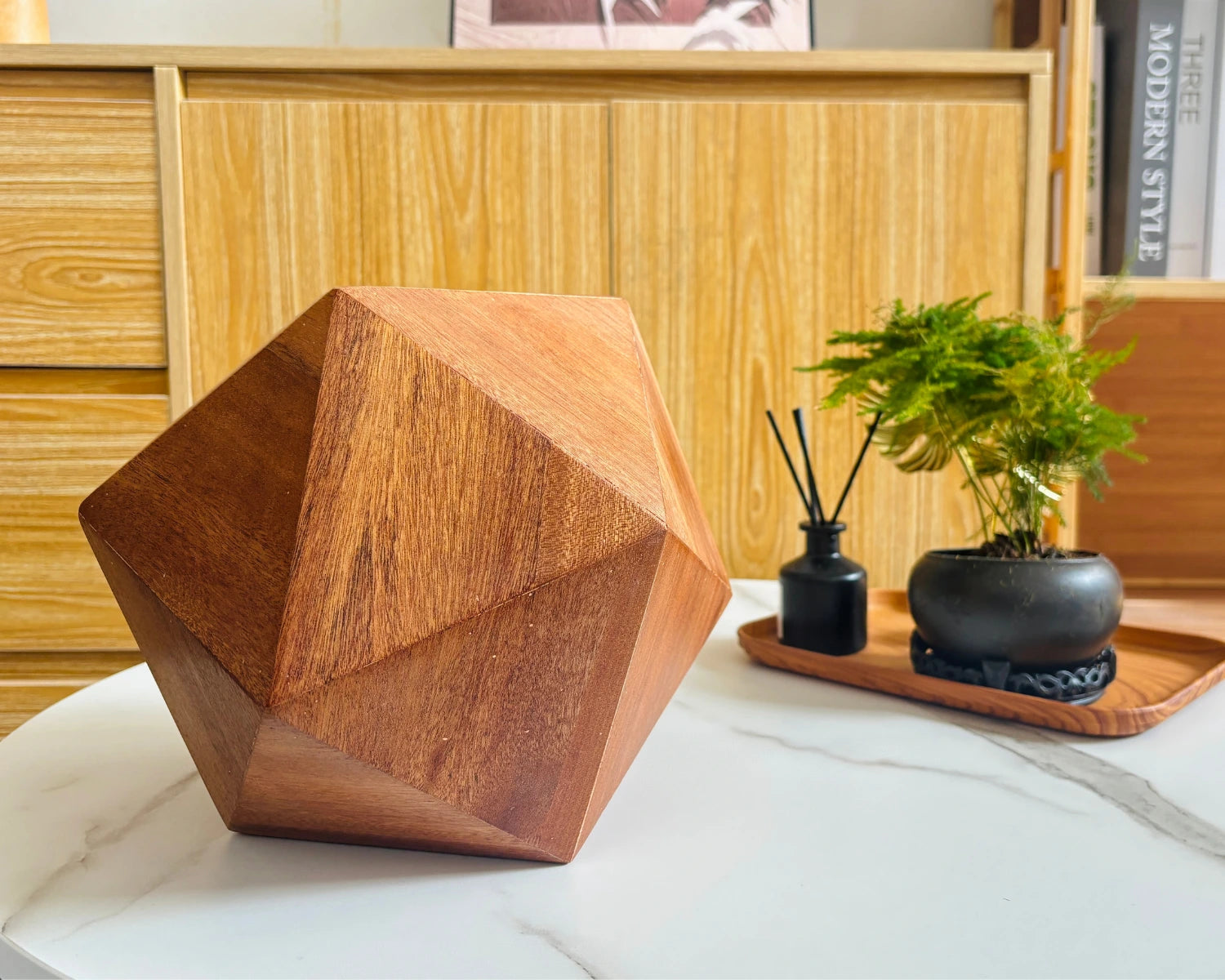 Sapele icosahedron pet urn placed on table
